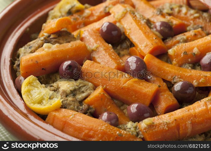 Moroccan dish with chicken, carrots, olives and preserved lemon close up