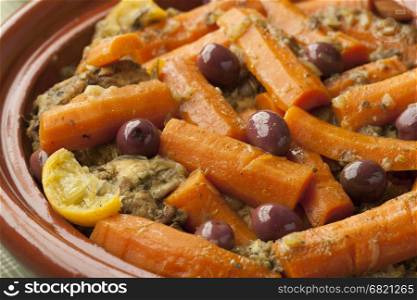 Moroccan dish with chicken, carrots, olives and preserved lemon close up