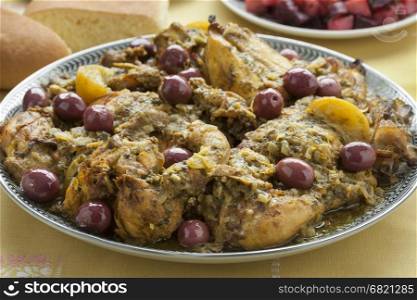 Moroccan dish with chicken, preserved lemon and purple olives close up