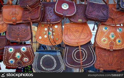 Moroccan leather goods bags in a row at outdoor market
