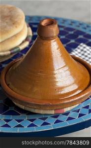 Moroccan tagine and bread on the table