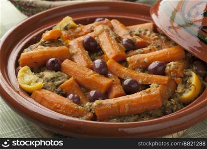 Moroccan tagine with chicken, carrots, olives and preserved lemon close up