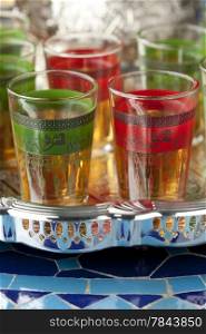 Moroccan tea glasses in the colors of the Moroccan flag with in Arabic letters written tea