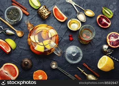 Moroccan tea, tea kettle with grapefruit, orange, lime and mandarin.. Fruit tea with citrus.