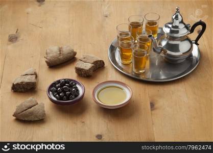 Moroccan traditional breakfast with olive oil,black olives,bread and tea