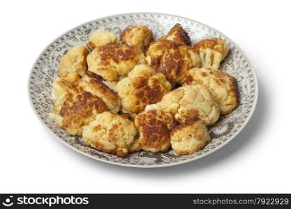 Moroccan traditional deep fried cauliflower on a dish on white background