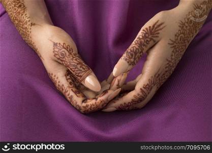 Moroccan woman with traditional henna painted hands