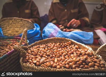 Moroccan women working with argan seeds to extract argan oil. Essaouira, Morocco.
