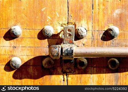 morocco knocker in africa the old wood facade home and rusty safe padlock