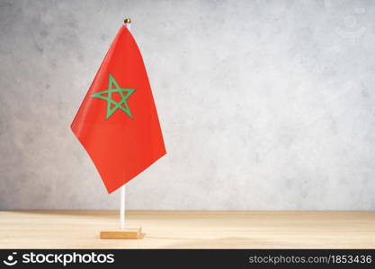 Morocco table flag on white textured wall. Copy space for text, designs or drawings