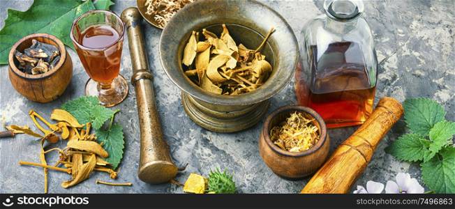 Mortar and bowl of raw and dried healing herbs.Alternative or herbal medicine. Herbal naturopathic medicine