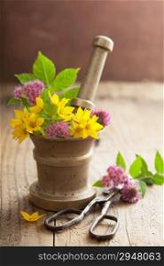mortar with flowers and herbs
