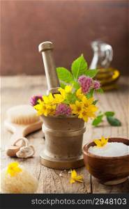 mortar with flowers and herbs for spa and aromatherapy