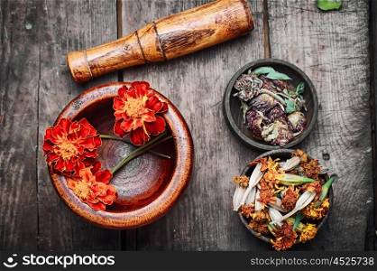 Mortar with healing flowers, plant marigolds