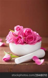 mortar with rose flowers for aromatherapy and spa