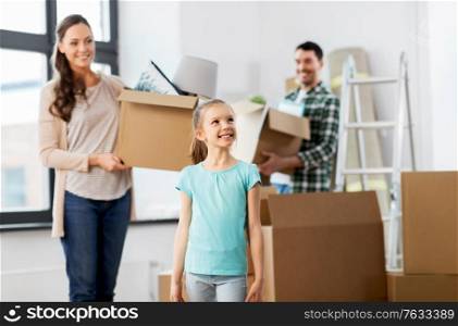 mortgage, family and real estate concept - happy mother, father and little daughter with stuff in boxes moving to new home. happy family with child moving to new home