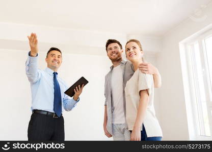 mortgage, people and real estate concept - happy couple and realtor with tablet pc computer at new home. couple and realtor with tablet pc at new home