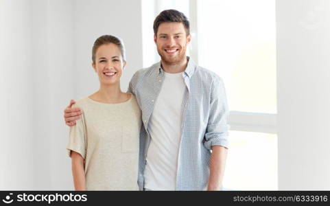 mortgage, people and real estate concept - happy couple at new home. happy couple at new home