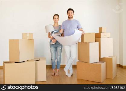 mortgage, people and real estate concept - happy couple with boxes and blueprint moving to new home. couple with boxes and blueprint moving to new home