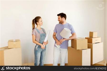 mortgage, people and real estate concept - happy couple with boxes and lamp moving to new home. couple with boxes and lamp moving to new home