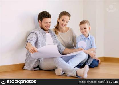 mortgage, people, housing and real estate concept - happy family with blueprint or house project moving to new home. happy family with blueprint moving to new home
