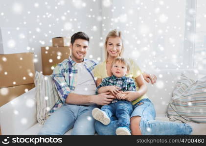 mortgage, people, housing and real estate concept - happy family with boxes moving to new home over snow