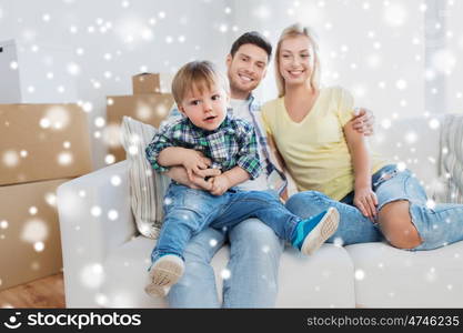 mortgage, people, housing and real estate concept - happy family with boxes moving to new home over snow