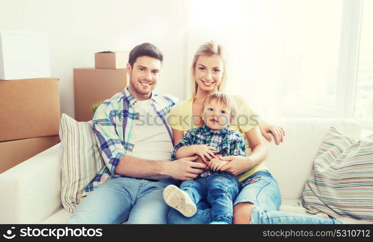 mortgage, people, housing and real estate concept - happy family with boxes moving to new home. happy family with boxes moving to new home