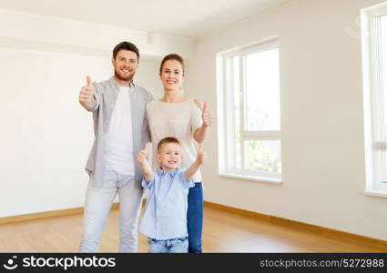 mortgage, people, housing and real estate concept - happy family with child moving to new home and showing thumbs up. happy family with child moving to new home