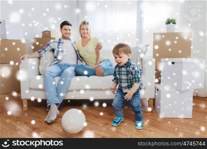mortgage, people, housing, moving and real estate concept - happy family with boxes and little boy playing ball at new home over snow