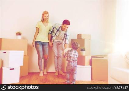 mortgage, people, housing, moving and real estate concept - happy family with boxes playing ball at new home