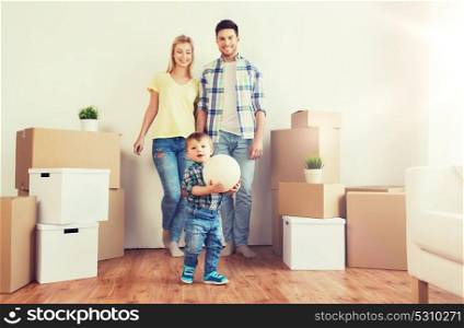 mortgage, people, housing, moving and real estate concept - happy family with boxes playing ball at new home. happy family moving to new home and playing ball