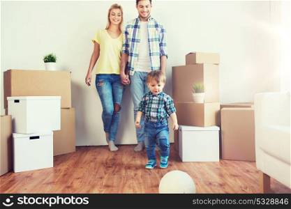 mortgage, people, housing, moving and real estate concept - happy family with boxes playing ball at new home. happy family moving to new home and playing ball