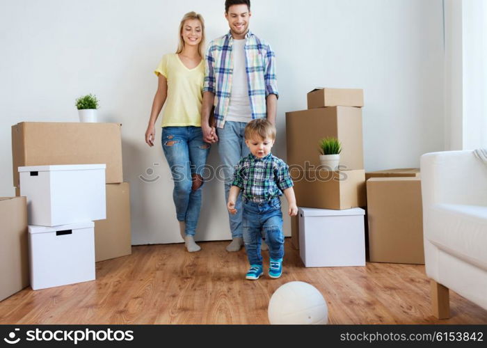 mortgage, people, housing, moving and real estate concept - happy family with boxes playing ball at new home