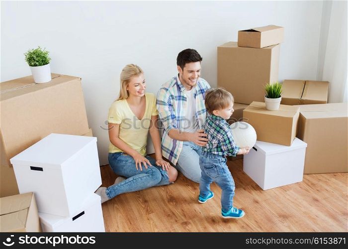 mortgage, people, housing, moving and real estate concept - happy family with boxes playing ball at new home