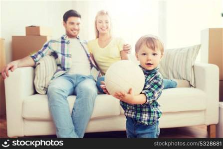 mortgage, people, housing, moving and real estate concept - happy little boy with ball over parents at home. happy little boy with ball over parents at home