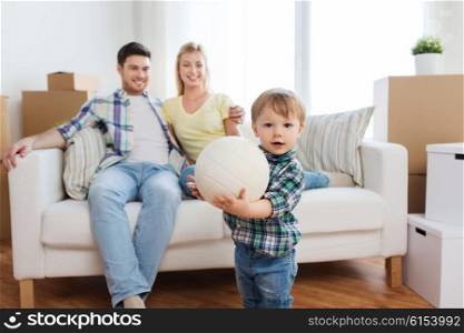 mortgage, people, housing, moving and real estate concept - happy little boy with ball over parents at home