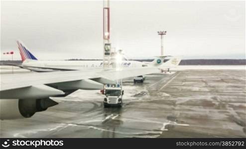MOSCOW, RUSSIA-APRIL 8, 2013: De-ice a plane. De-icing is defined as removal of snow, ice or frost from a surface.
