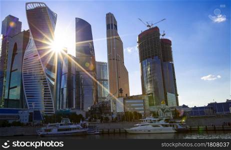 MOSCOW. RUSSIA - JULE 11, 2021:The Skyscrapers of the Moscow City International Business Center and lights of a sun. Skyscrapers of the Moscow City International Business Center and lights of a sun