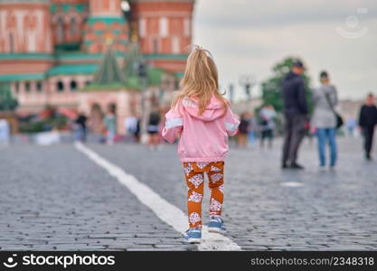 Moscow, Russia - May 27, 2021  A little girl with a child’s camera walks along Red Square. Moscow, Russia - May 27, 2021  A little girl with a child’s camera walks along Red Square.