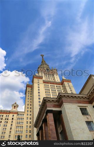 Moscow State University against bright blue sky with white clouds