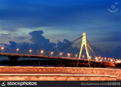 Moskovsky bridge across Dnepr river in Kiev city at night