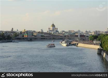 Moskva river with river buses from Novoandreevskiy Bridge. Krymsky bridge and Cathedral of Christ the Savior on the horizon in Moscow, Russia. Moskva river with river buses from Novoandreevskiy Bridge. Krymsky bridge and Cathedral of Christ the Savior on the horizon in Moscow, Russia.