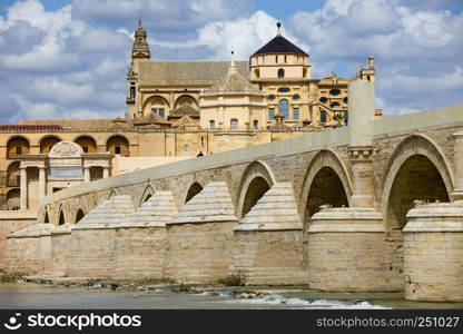 Mosque Cathedral (La Mezquita) and Roman Bridge on Guadalquivir river in Cordoba, Spain, Andalusia region.