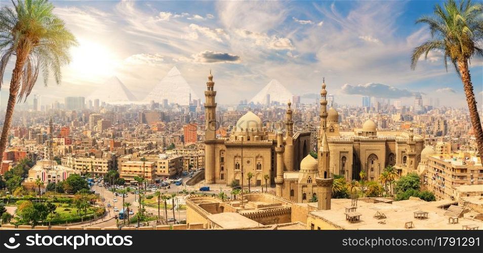 Mosque-Madrasa of Sultan Hassan behind the palm trees, Cairo, Egypt.