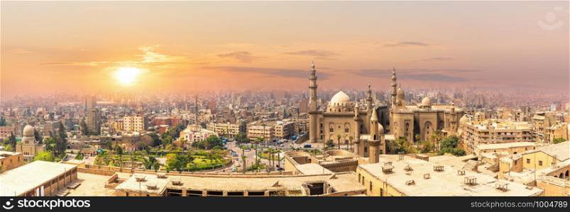 Mosque-Madrassa of Sultan Hassan in the sunset panorama of Cairo, Egypt.. Mosque-Madrassa of Sultan Hassan in the sunset panorama of Cairo, Egypt