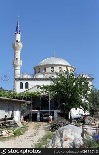 Mosque with high minarets in turkish village in Turkey
