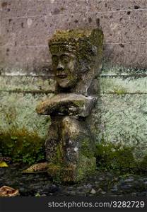 Moss covered figurine in Bali