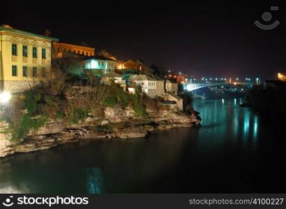 Mostar old town at night with the Luka Bridge above the Neretva river.