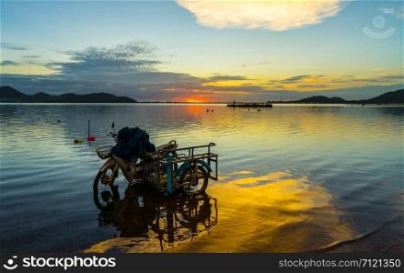 motercycle parked on the waterfront with sunset at Bang phra reservoir ,sriracha chon buri, thailand